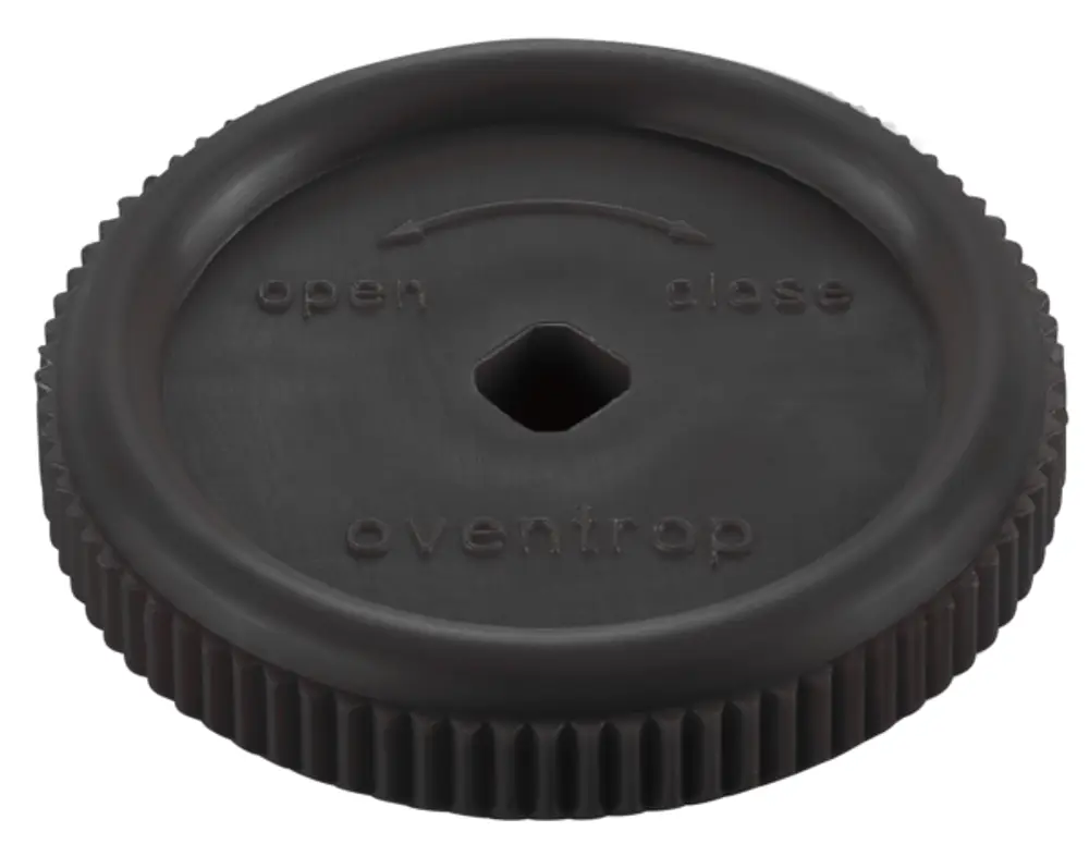 Schwarzes Handrad mit umlaufender Riffelung und einem hexagonalen Loch in der Mitte, beschriftet mit "open", "close" und "oventrop".